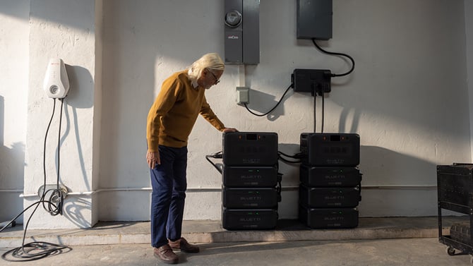 Bluetti Apex 300 portable power station shown used in parallel stacked in a garage and hooked up to the home's power 