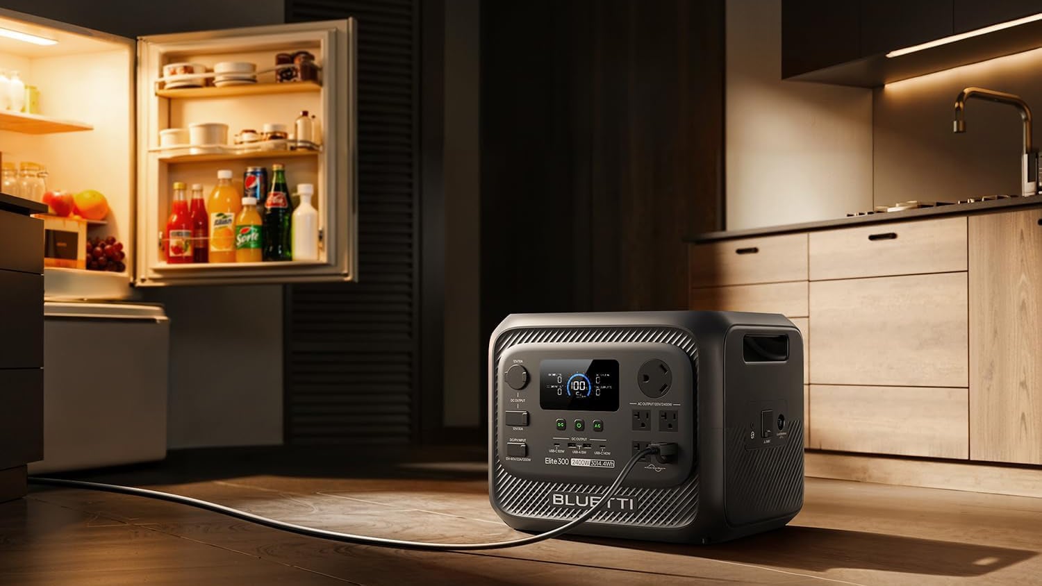 BLUETTI Elite 300 portable power station on a kitchen floor beside an open, illuminated refrigerator.