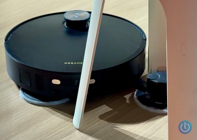 The Dreame NEXT X60 Ultra's arm extends to clean around a chair leg.