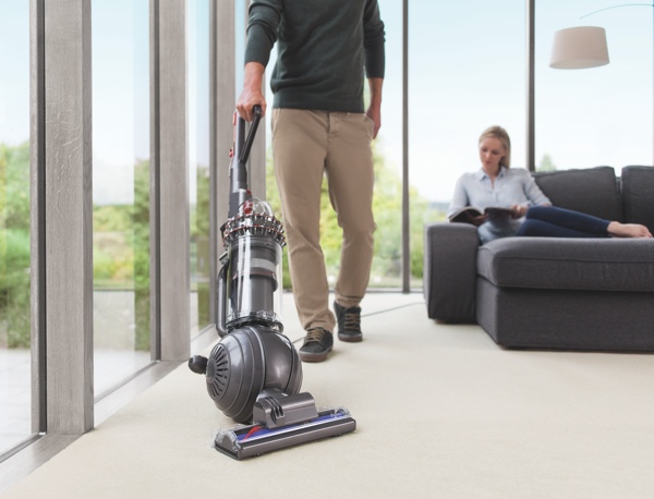 Dyson Cinetic Big Ball upright vacuum being used on carpeting