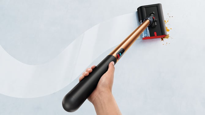 The Dyson PencilWash is shown from above, held in one hand.