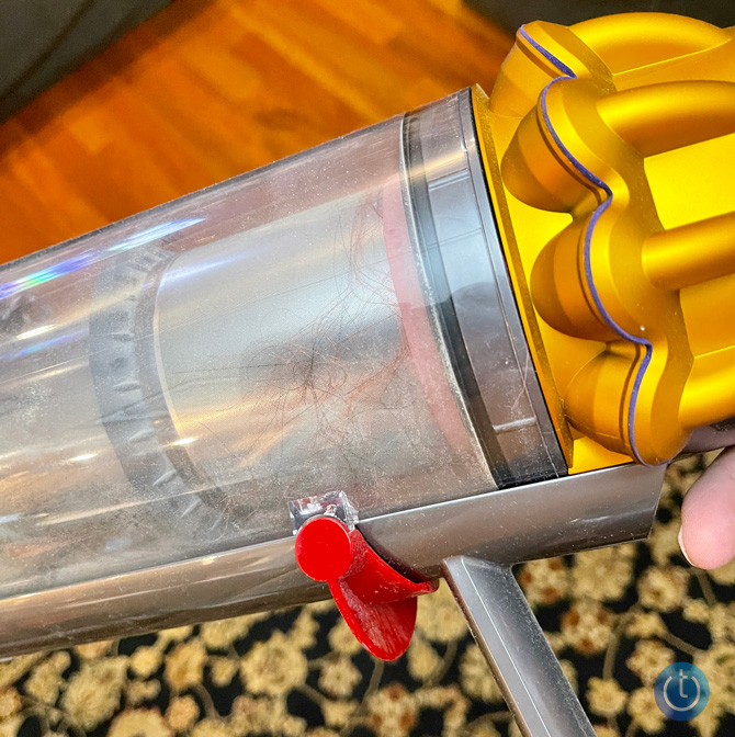 Closeup of Dyson V15 Detect dustbin with debris inside, including long hair