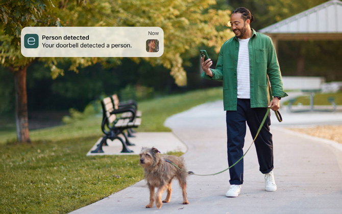 Notification concept showing a man walking a dog with a notification that says: Person detected. Your doorbell detected a person. 