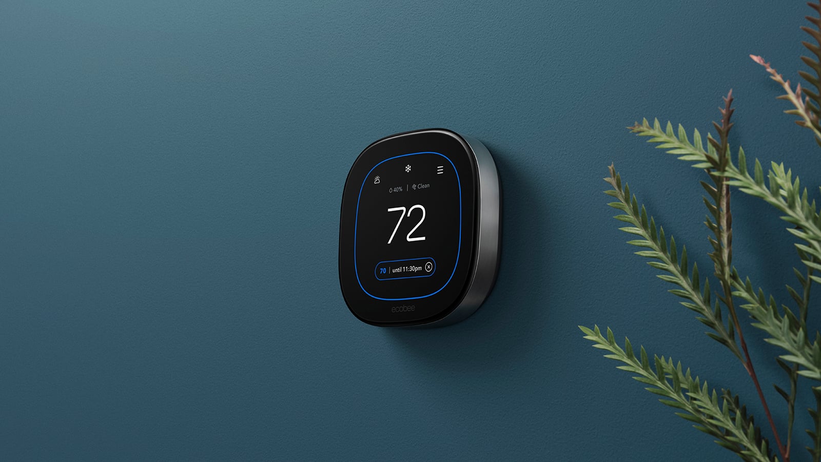 Ecobee Smart Thermostat Premium mounted on a teal wall, displaying 72 degrees with a cooling target of 70 degrees.