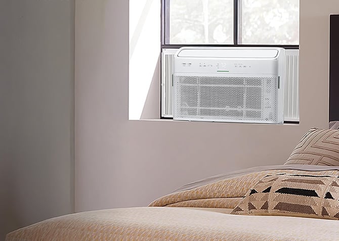 Frigidaire Gallery Smart Inverter Window Air Conditioner is shown installed in a window.