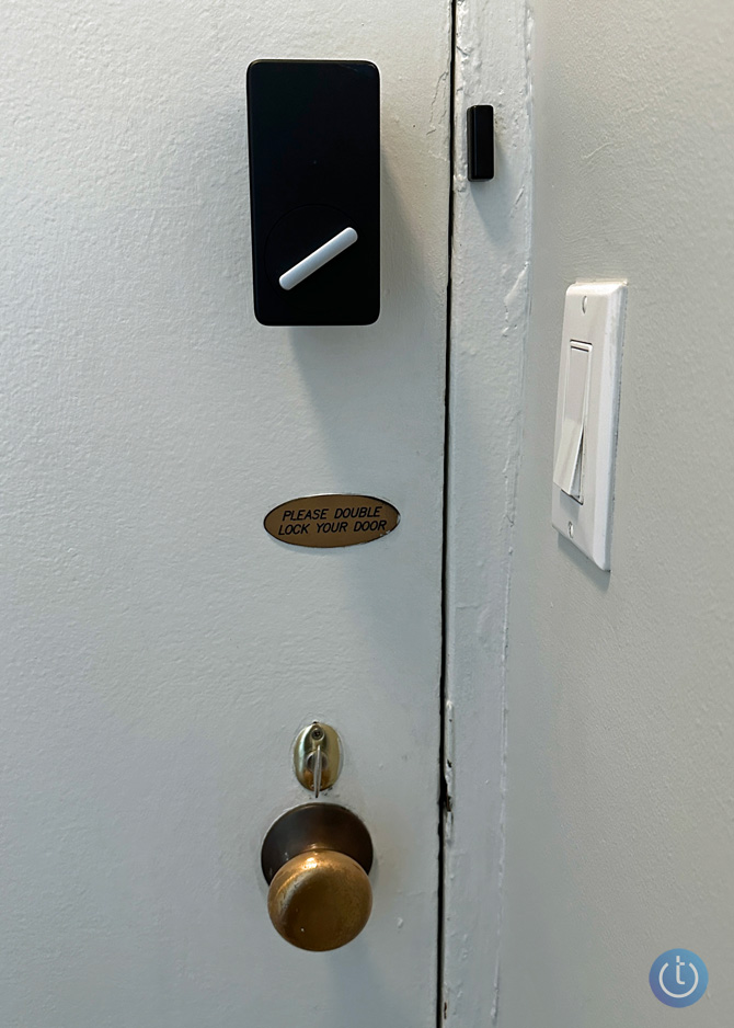 Inside of my front door with the SwitchBot installed on the top lock. There is another thumb turn lock just above the door handle. 