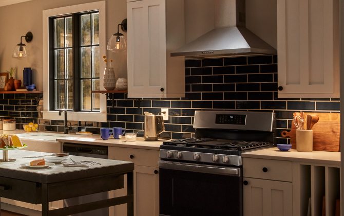 Cync Reveal HD+ Full Color Undercabinet Fixtures installed in a kitchen. You can see under cabinet lighting on both sides of the stove.