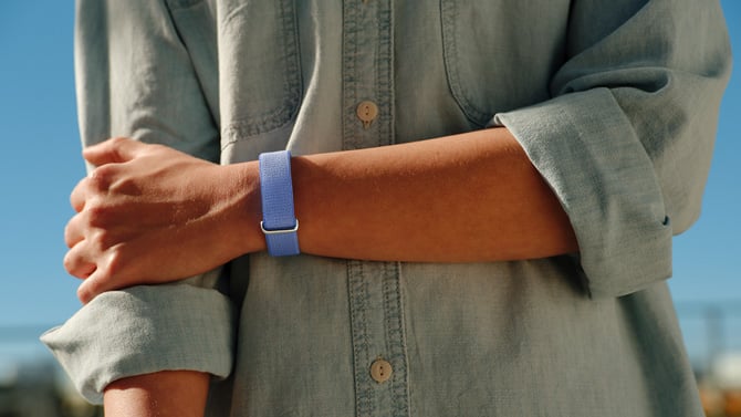 Fitbit Air shown is shown in a lavender performance band.