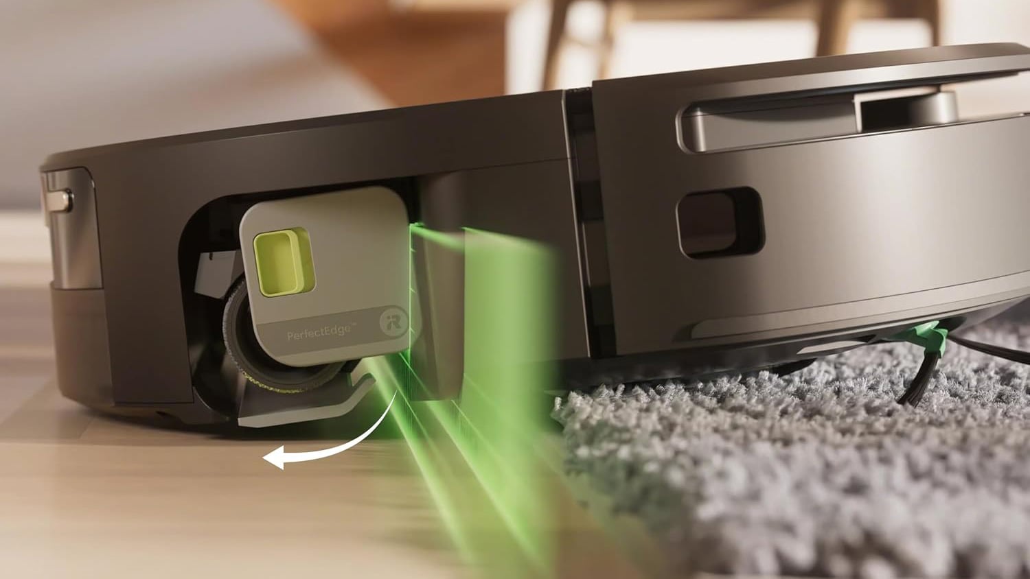 Close-up of a Roomba 705 robot vacuum at the edge of a rug, with a green graphic highlighting its mop-covering mechanism.