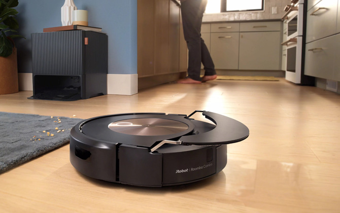 iRobot Roomba Combo j9+ showing the retractable arm in action. The base is seen in th upper left.