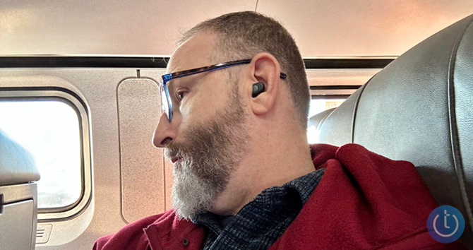 Jabra Enhance Plus earbud shown on writer in ear from the side.