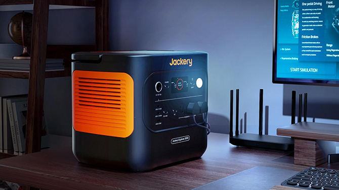 Jackery Explorer 2000 v2 is shown powering a desktop computer.