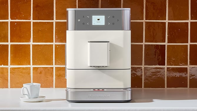 The KitchenAid FK6 Fully Automatica Espresso Machine is shown in porcelain on a counter.