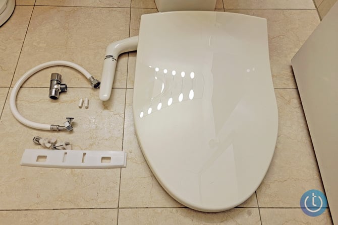 Kohler Puretide bidet with all components in the box - hose, mounting bracket, t-valve, spray tube, 