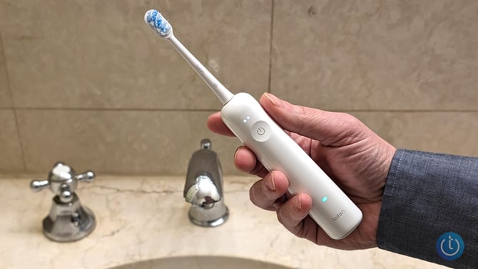 Laifen Wave Toothbrush shown held in the writer's hand.