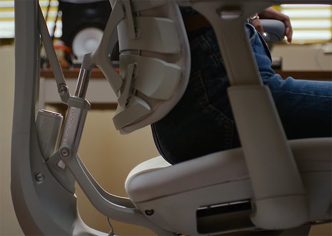 The LiberNovo Omni chair shown from the side supporting a person's spine