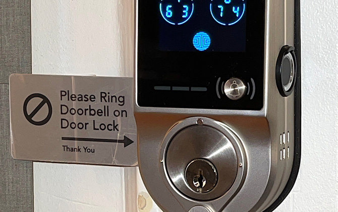 Lockly Vision exterior of door lock with doorbell sign identified