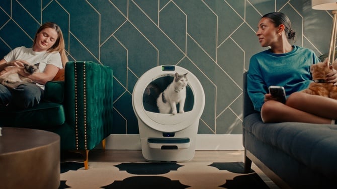 Two women sitting next to Whisker LR5