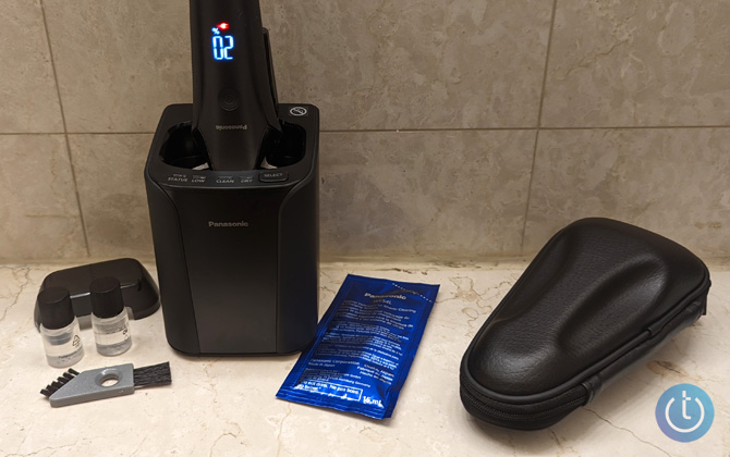 Panasonic Arc6 with in-box accessories from the left: foil cover, two bottles of oil, two-headed brush, wash station, packet of wash solution, and a carry case.  