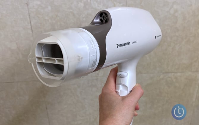 Panasonic’s Nanoe EH-NA67-W hair dryer with oscillating attachment shown from the front against marble background