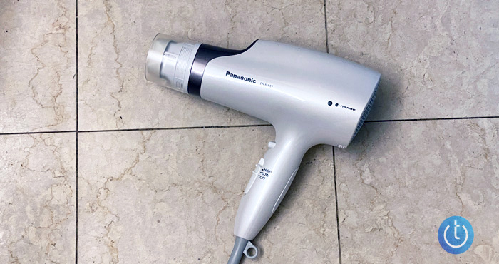 Panasonic’s Nanoe EH-NA67-W hair dryer with oscillating attachment on marble background