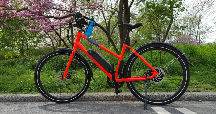 RadMission bike on bike path in Central Park in front of flowering tree in New York City