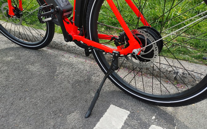 Closeup of RadMission 1 rear wheel and disc brake, plus kickstand