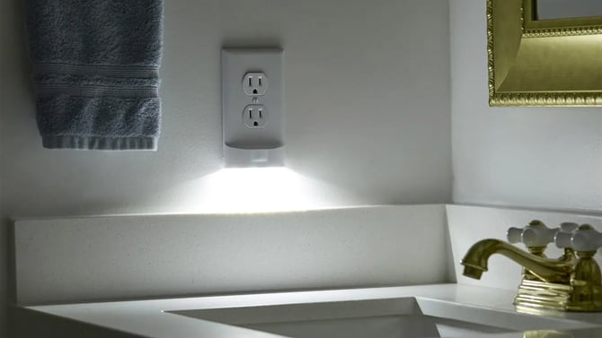 SnapPower MotionLight shown in a bathroom at night.