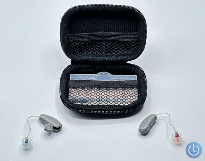 Soundwaver Sontro show with carrying case. The hearing aid on the left has the battery door open. 