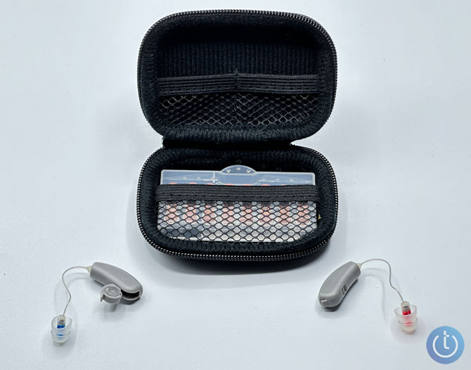 Soundwaver Sontro show with carrying case. The hearing aid on the left has the battery door open. 