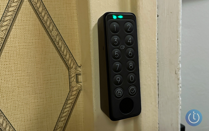 SwitchBot Keypad Touch shown mounted on door frame with a green light indicating the lock is opening.