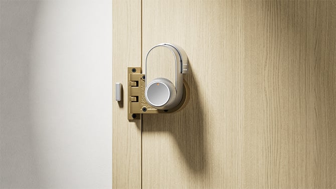 The SwitchBot Ultra Lock shown in silver with the light wood wrap