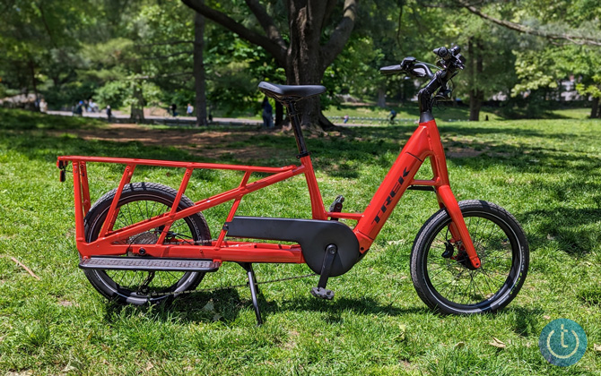 Trek Fetch+ 2 shown from the side parked under a tree in Central Park.