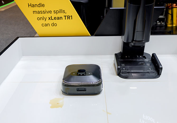 xlean robot next to base unit, with handle stored in base unit.