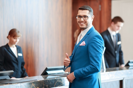 Man at front desk of hotel