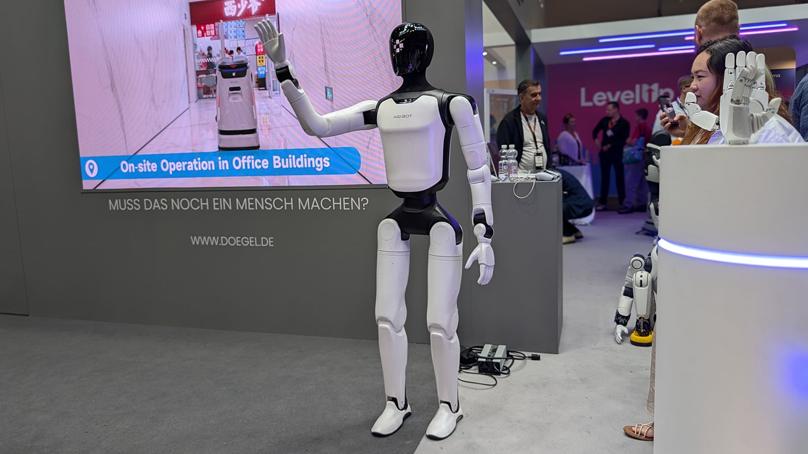 AGIBOT A3 humanoid robot waves to passersby.