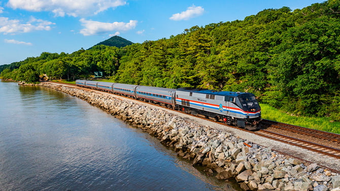 An Amtrak train traverses the Cascades in the summer.