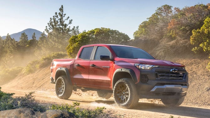 2023 Chevrolet Colorado driving on a dusty road.