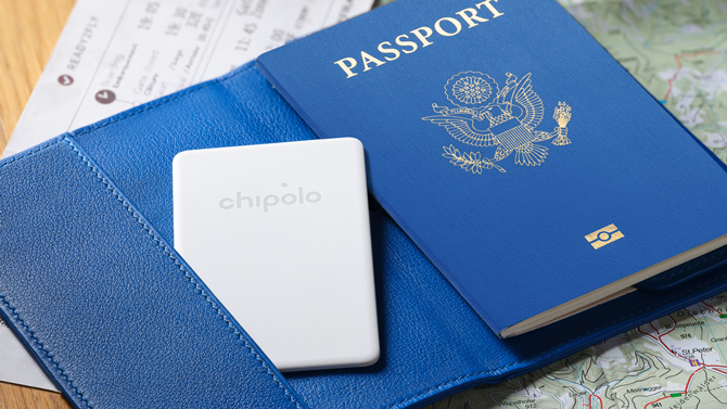 Chipolo CARD Point shown sticking out of a passport holder.