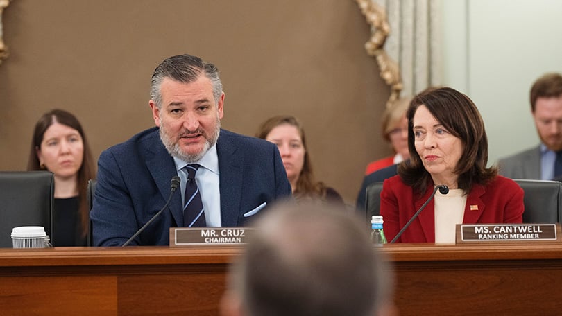 Sen. Ted Cruz speaks beside Sen. Maria Cantwell during a Senate Commerce Committee hearing.