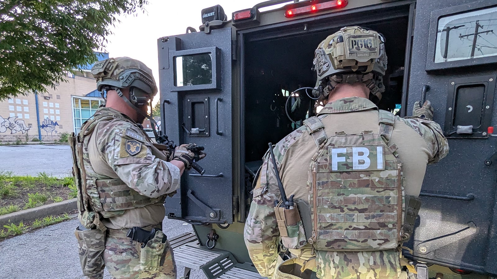Two members of the FBI Pittsburgh SWAT team prepare for an arrest effort in support of Operation Turf War in Baltimore, Maryland, on June 2, 2026.