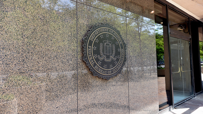 The outside of the FBI building shows the FBI seal.