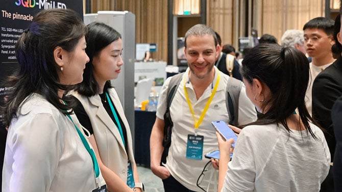 Josh Kirschner standing with company representatives on the Global Connect Showfloor