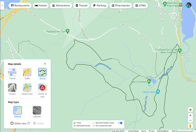 Google Maps screenshot showing Map details box with Transit, Traffic, Biking, Terrain, Street View , COVID-19 info, and satellite options. Plus a legend box showing dark green for trails, lighter green for dedicated bike lanes, dotted green line for bicycle-friendly roads and brow for dirt/unpaved trails. At the top are options for searching for ATMs, Pharmacies, Parking, Transit, Attractions, Hotels, and Restaurants. 