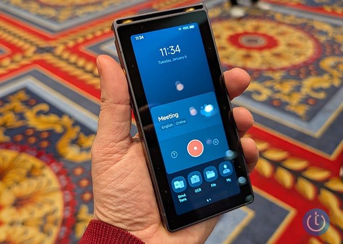 iFLYTEK S6 recorder shown held in hand, about the size of a cellphone with a large display