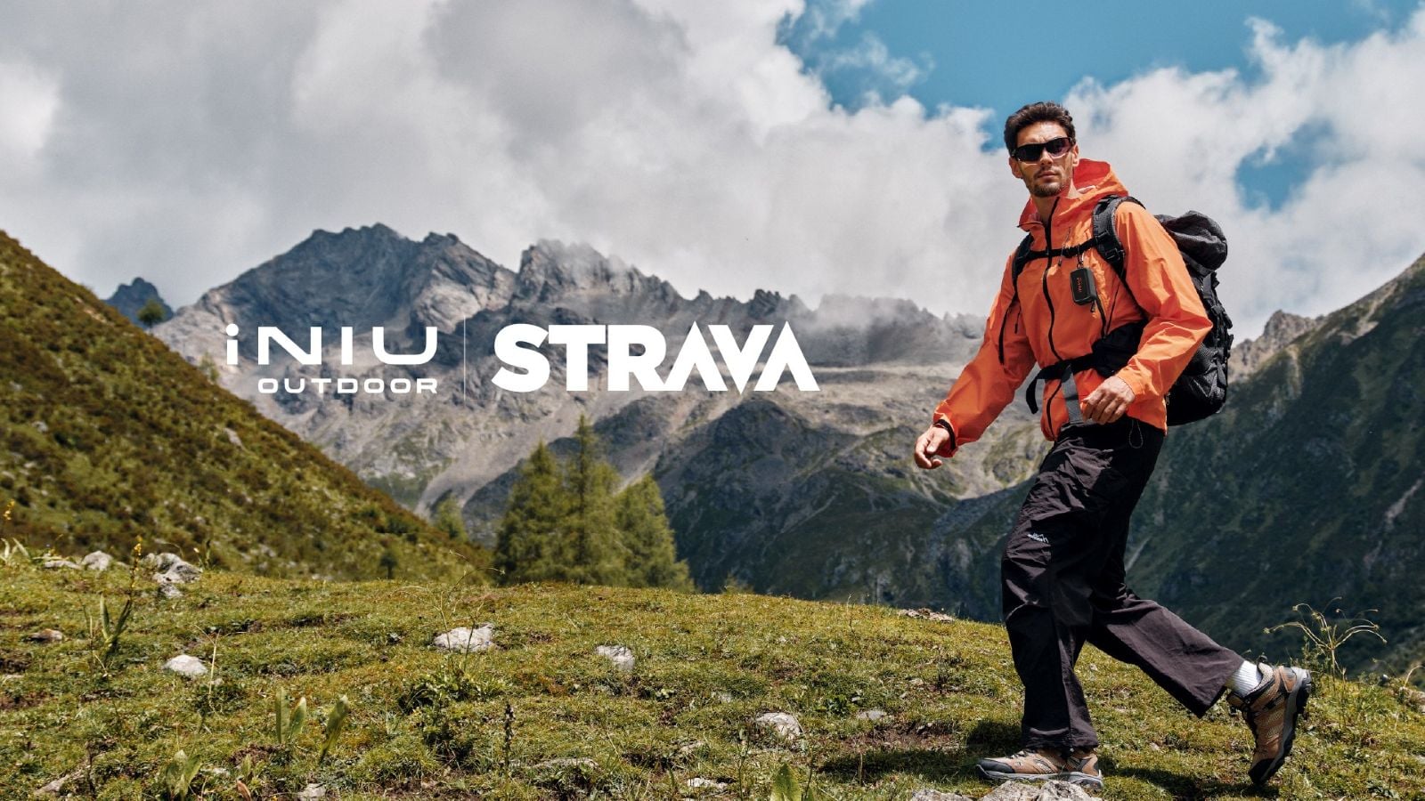 Hiker on a forested slope with a small olive power bank clipped to a backpack strap. Text overlay with INIU Outdoor and Strava logos.