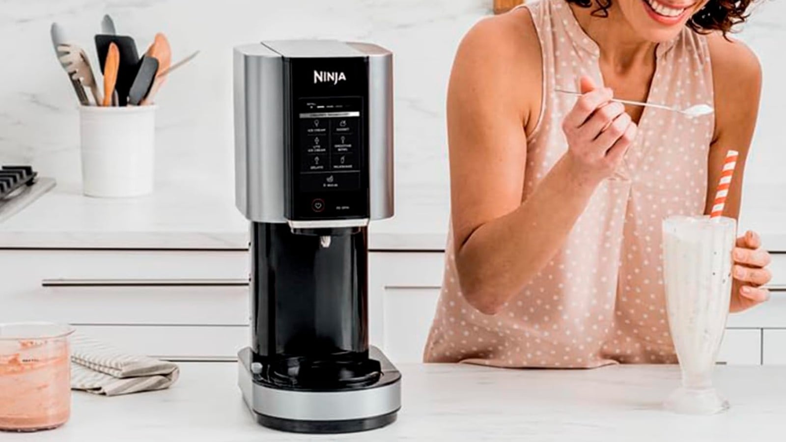 Ninja Creami on a counter next to a woman