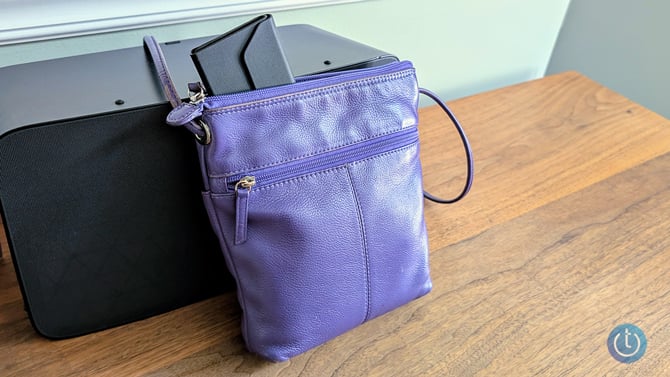 Satechi FindAll Glasses Case folded flat and sticking out of a purse