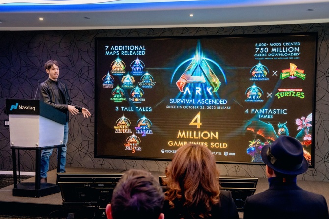 Jeremy Stieglitz on stage with a slide showing Ark 4 million games sold
