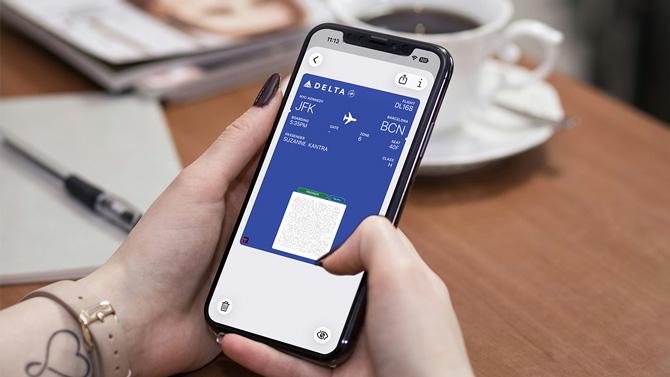 A person checks their boarding mobile boarding pass.
